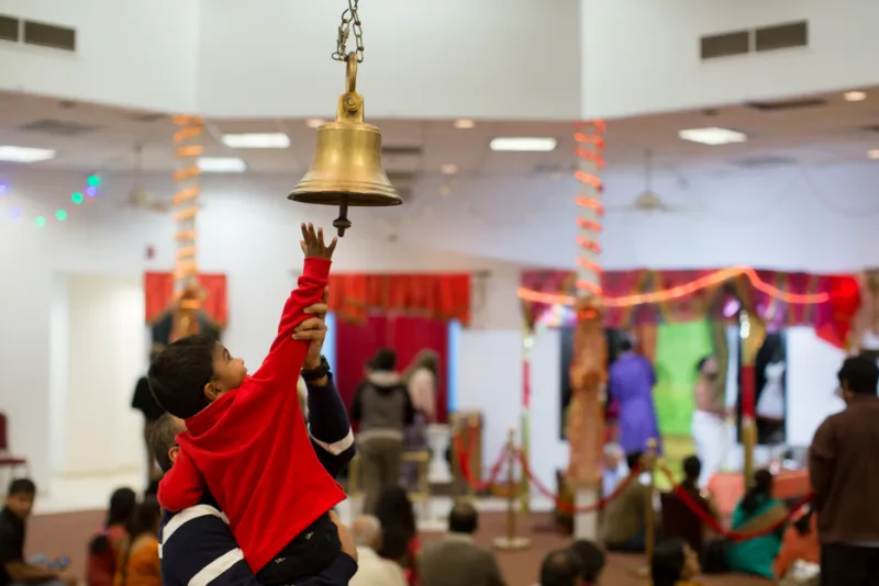 Child ringing a bell